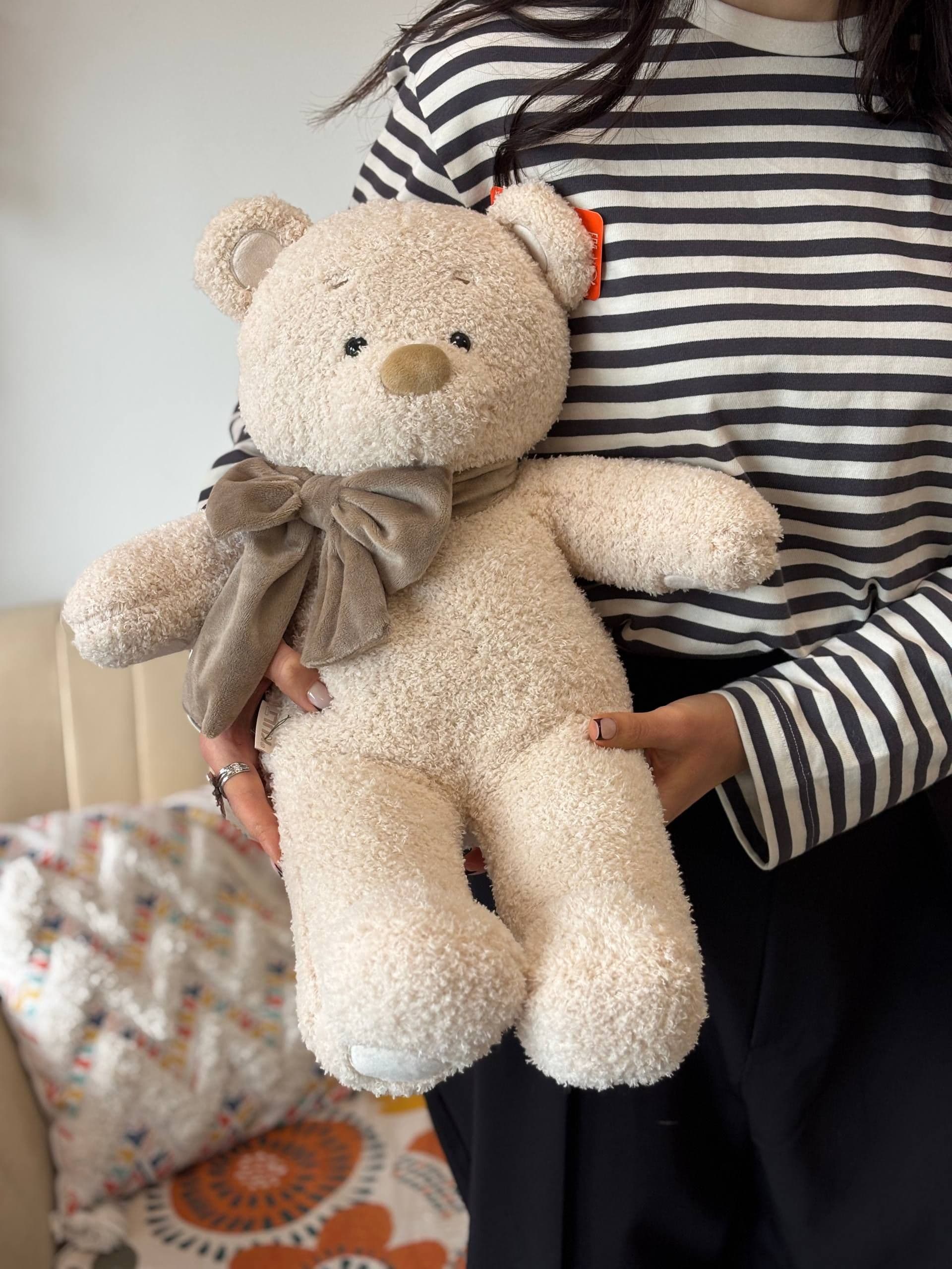 "Milky Cody" plush toy with a bow